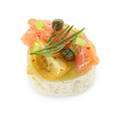 Tasty canape with salmon, tomatoes, capers and herbs isolated on white