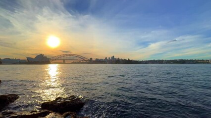 Wall Mural - Monday 29 April 2024 Sydney Harbour forshore viewed from the Gardens in NSW Australia at sunset with colourful orange pink and blue skies