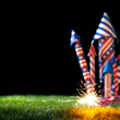 4th of July bottle rockets or fireworks in USA colors of red, white, and blue with lit sparkling fuse for patriotic US American 4th of July celebration.