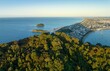 Aerial: Mount Maunganui, the township, beach and the harbour into Tauranga, Bay Of Plenty, New Zealand