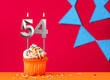 Number 54 candle with birthday cupcake on a red background with blue pennants