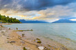 View from the Sirmione public beach of the shoreline and Passeggiata delle Muse hiking area in the resort town of Sirmione, Italy, on the shores of Lake Garda in the Lombardy region of Northern Italy.