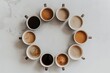 © MeSSrro - A top view of some coffee cups on a white background and they're in different types and colors.