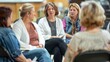 © Justlight - The the sits at the head of the group guiding the discussion and offering supportive words..