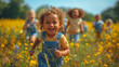 A cute young toddler running on a field of wildflowers with his friends