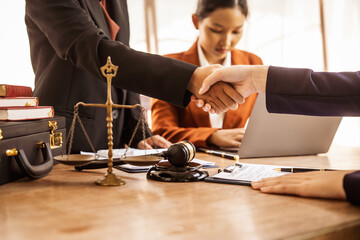 Wall Mural - Shaking hands, Lawyers offer legal guidance, stand for clients in court, and aid with legal paperwork. analyze laws to safeguard clients' rights and interests, fair representation and justice.