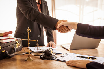 Wall Mural - Shaking hands, Lawyers offer legal guidance, stand for clients in court, and aid with legal paperwork. analyze laws to safeguard clients' rights and interests, fair representation and justice.