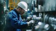 © ORG - Engineer in blue jumpsuit and white hard hat lathe Checking machinery in the factory