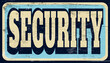 Aged and worn security sign on wood