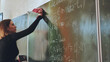 A girl washes the school blackboard after a maths lesson.