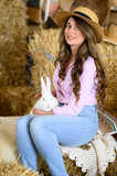 Fototapeta  - Woman in pink shirt playing with a white bunny rabbit