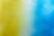yellow and blue color spray paint gradient on white color paper