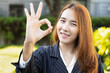 Asian office worker woman showing accepting ok gesture, concept image for All Correct, good job, acceptance, approving action, work with success, done deal, accomplishment, position promotion