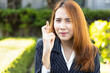Excited Asian office worker woman showing wishing with finger crossed gesture