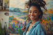 Young artist smiles while painting a colorful landscape
