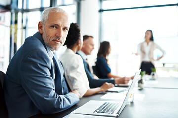 Poster - CEO, mature man and laptop in boardroom, meeting and listening to presentation by employee for team. Portrait, boss and online for project, collaboration and strategy for deal, editor and publishing