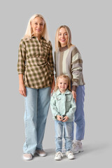 Canvas Print - Cute little girl with her mother and granny on light background