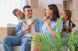 © Pixel-Shot - Happy family hugging at home on moving day