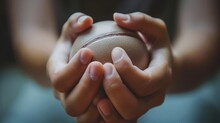 A Close-up Of Hands Clutching A Stress Ball Tightly, Veins Visible From The Pressure.