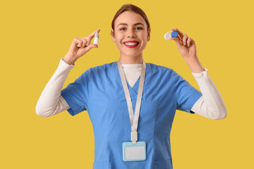 Poster - Female ophthalmologist with eye drops and contact lenses on yellow background