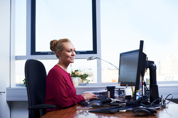 Business woman, computer and online working on digital legal brief at office. Lawyer, planning and professional with internet and website research for labour law case at attorney consultant company