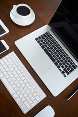 Poster - Laptop, mobile and tablet in office with digital devices for business research, communication or collaboration. Smartphone, mouse and coffee in workspace with tech for online company or connection