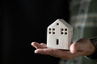Man hand holding a house model in his hand,The concept of owning a house or mortgaging real estate
