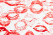 Imprint of red lips on white paper, kiss background