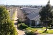 A row of new and modern residential suburban houses in a new developed estate in a Melbourne’s suburb. Many Australian homes on a straight street. Aintree, VIC Australia. Concept of growing population