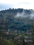 Fototapeta Uliczki - Fog Whispering Through a Mountain Village