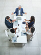 © peopleimages.com - Above, business people and clapping hands in office meeting for partnership, collaboration or celebration. Workplace, boardroom or team with applause for agreement, new project or work by top view