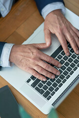 Poster - Top view, hands of businessman and laptop for typing in office for email, news research and connect. Professional, journalist or content writer as career, technology and male employee in workplace