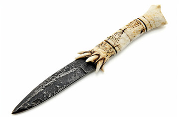 Savage and brutal tribal dagger with a jagged obsidian blade and intricately carved bone handle isolated on solid white background.