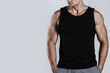 Muscular man wearing black tank top with blank space, ideal for a mockup