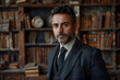 © Nansan - A Gentleman in a Suit and Tie Standing in a Library