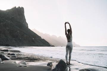 Wall Mural - Woman resting after yoga practice on the beach.