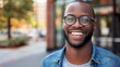 Radiant Smile with Glasses: Portrait of a Beautiful Young Black Man Sporting a Joyful Expression