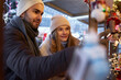 Caucasian couple on Christmas market at the stall
