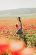© svetograph - Woman poppies field. portrait happy woman with long hair in a poppy field and enjoying the beauty of nature in a warm summer day.