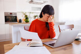 Fototapeta Koty - Woman doing home finances anxious and stressed out