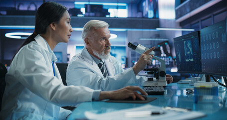 Poster - Biotechnology Medical Research Center: Female Asian Neurologist Using Desktop Computer And Talking To Male Caucasian Scientist With Microscope. Doctors Studying Brain Damage Cases, Finding Solutions.