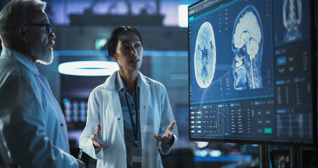 Poster - Neuroscience Laboratory Meeting: Female Asian Scientist And Male Caucasian Surgeon Discussing MRI Brain Scan On TV Display. Specialists Working On Medication For Rehabilitation After Brain Damage.