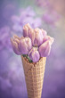 Purple tulips arranged in a waffle cone against a blurred background.