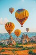 Vivid hot air balloons gracefully floating above awe inspiring mountain landscape