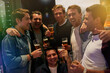 Men, beers and cheers with friends drinking at club, restaurant or party with happiness. People, alcohol and glasses at pub together for happy hour, conversation or gathering for celebration
