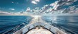 © Doni_Art - view from the bow of a luxury yacht, sea horizon with blue sky and clouds.