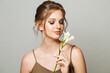 Spring woman with beautiful flowers. Healthy woman with natural makeup and fresh clean skin