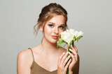 Fototapeta Niebo - Young beautiful woman and flowers