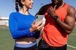 © Rawpixel.com - Male and female athletes looking at smartphone