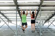 © Rawpixel.com - Man and woman fitness trainers using a cable machine